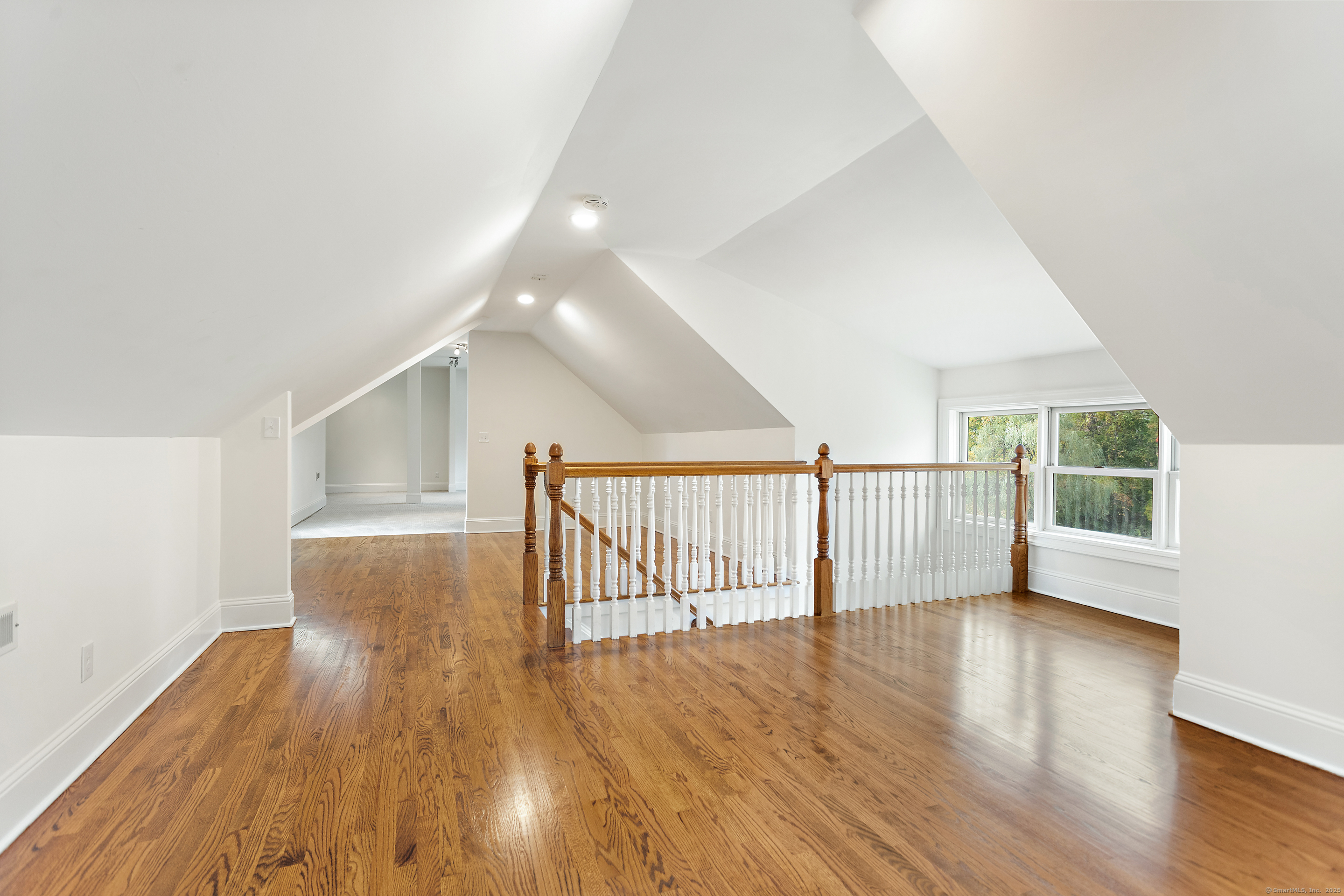 123 Greens Farms Road Westport, CT 06880 - Photo 35 of 40 a view of an empty room with wooden floor and a window