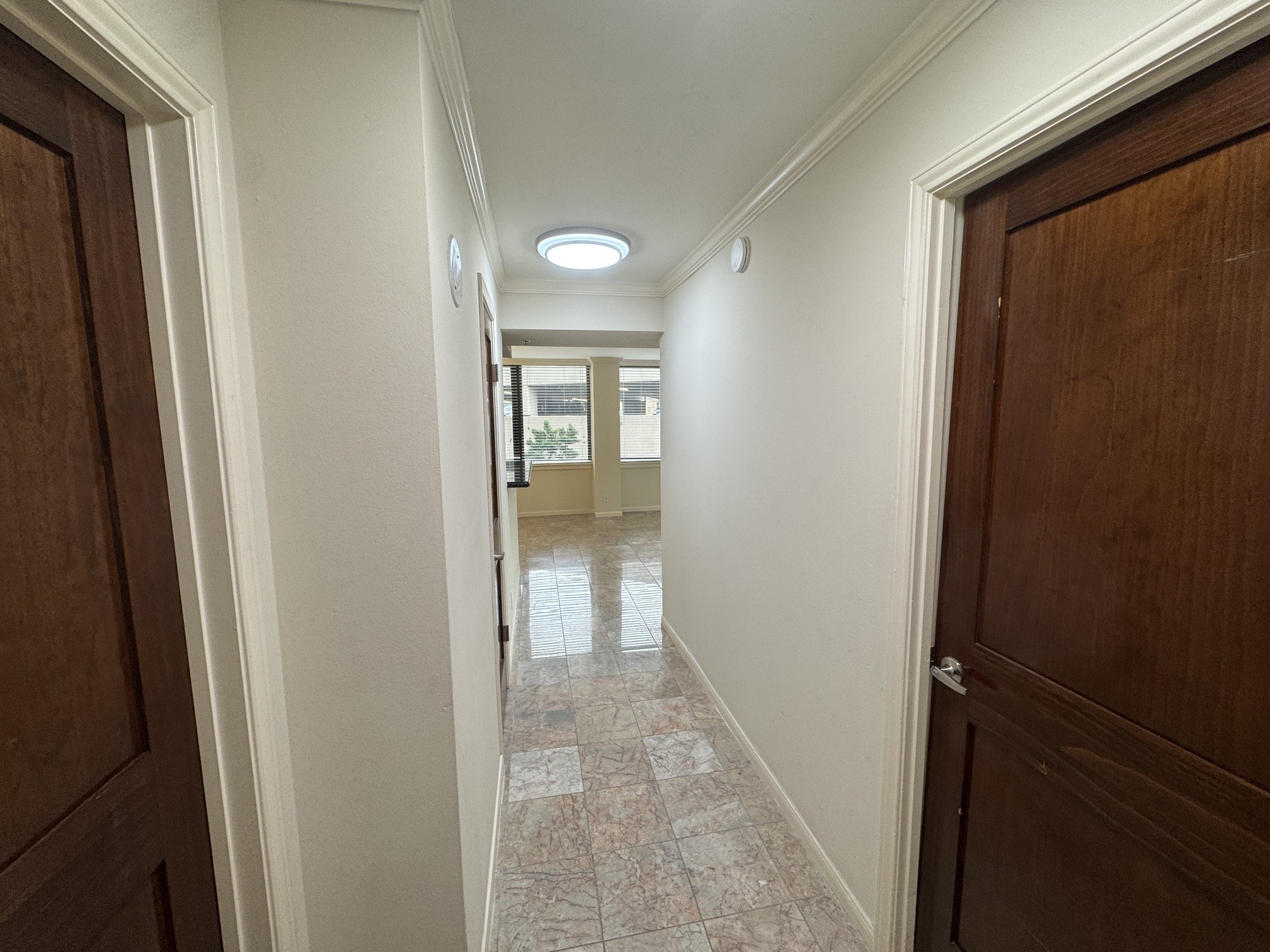 3525 Sage Road, Unit 404 Houston, TX 77056 - Photo 24 of 42 Entry hall from the front door passing full bath on the left and secondary bedroom on the right