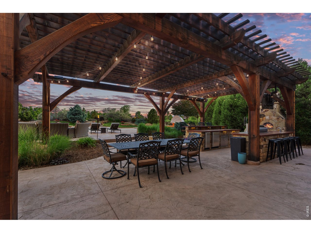 964 Riparian Way Fort Collins, CO 80524 - Photo 23 of 42 a view of a patio with table and chairs under an umbrella with a barbeque