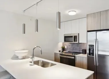 a kitchen with kitchen island a sink stainless steel appliances and cabinets