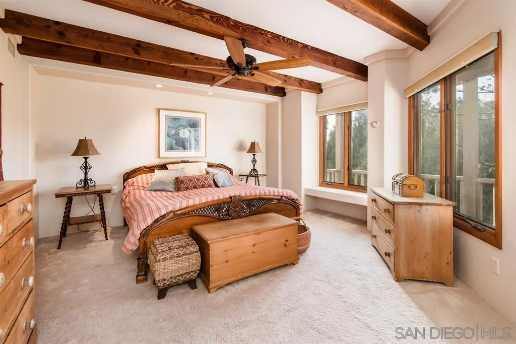 16722 Via Lago Azul Rancho Santa Fe, CA 92067 - Photo 15 of 20 a spacious bedroom with a bed and large windows