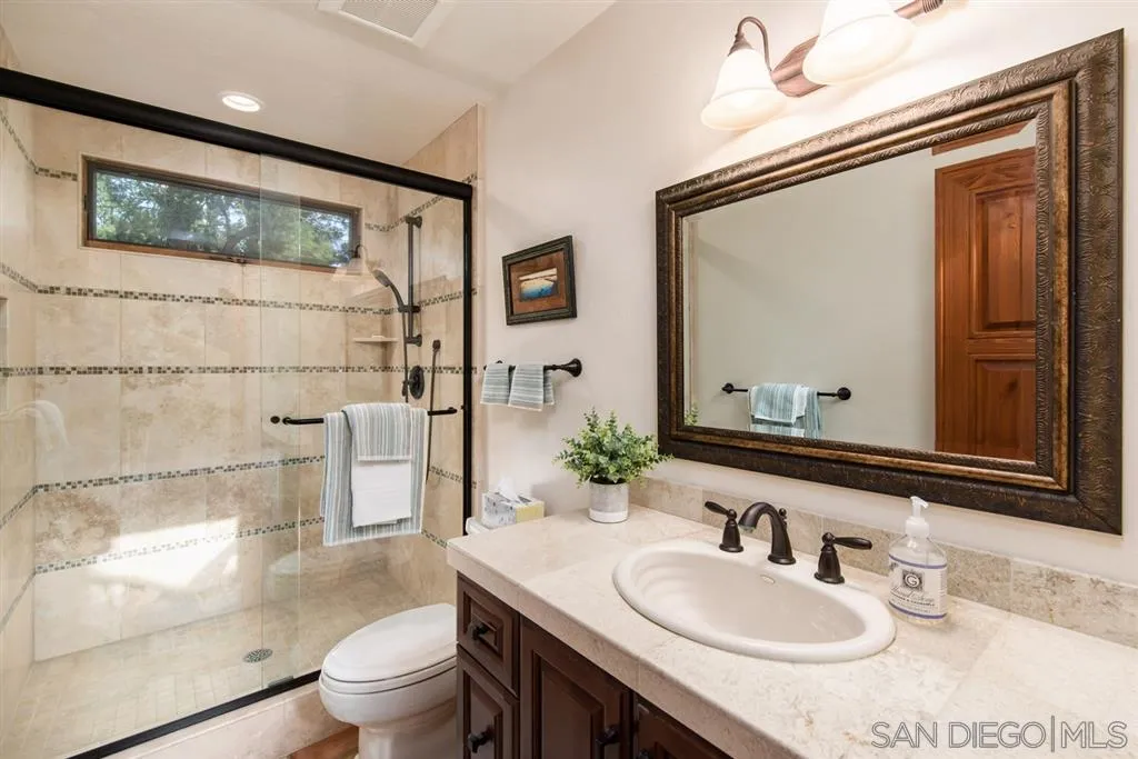 16722 Via Lago Azul Rancho Santa Fe, CA 92067 - Photo 16 of 20 a bathroom with a granite countertop sink mirror toilet and shower
