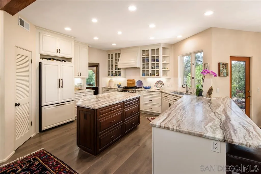 16722 Via Lago Azul Rancho Santa Fe, CA 92067 - Photo 3 of 20 a kitchen with stainless steel appliances granite countertop a refrigerator a sink and a stove