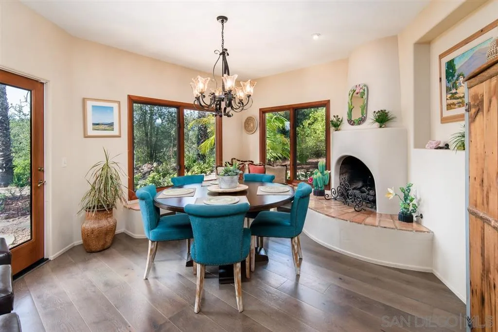 16722 Via Lago Azul Rancho Santa Fe, CA 92067 - Photo 8 of 20 a view of a dining room with furniture wooden floor and chandelier