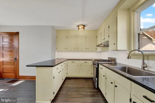 a kitchen with a sink stove and cabinets