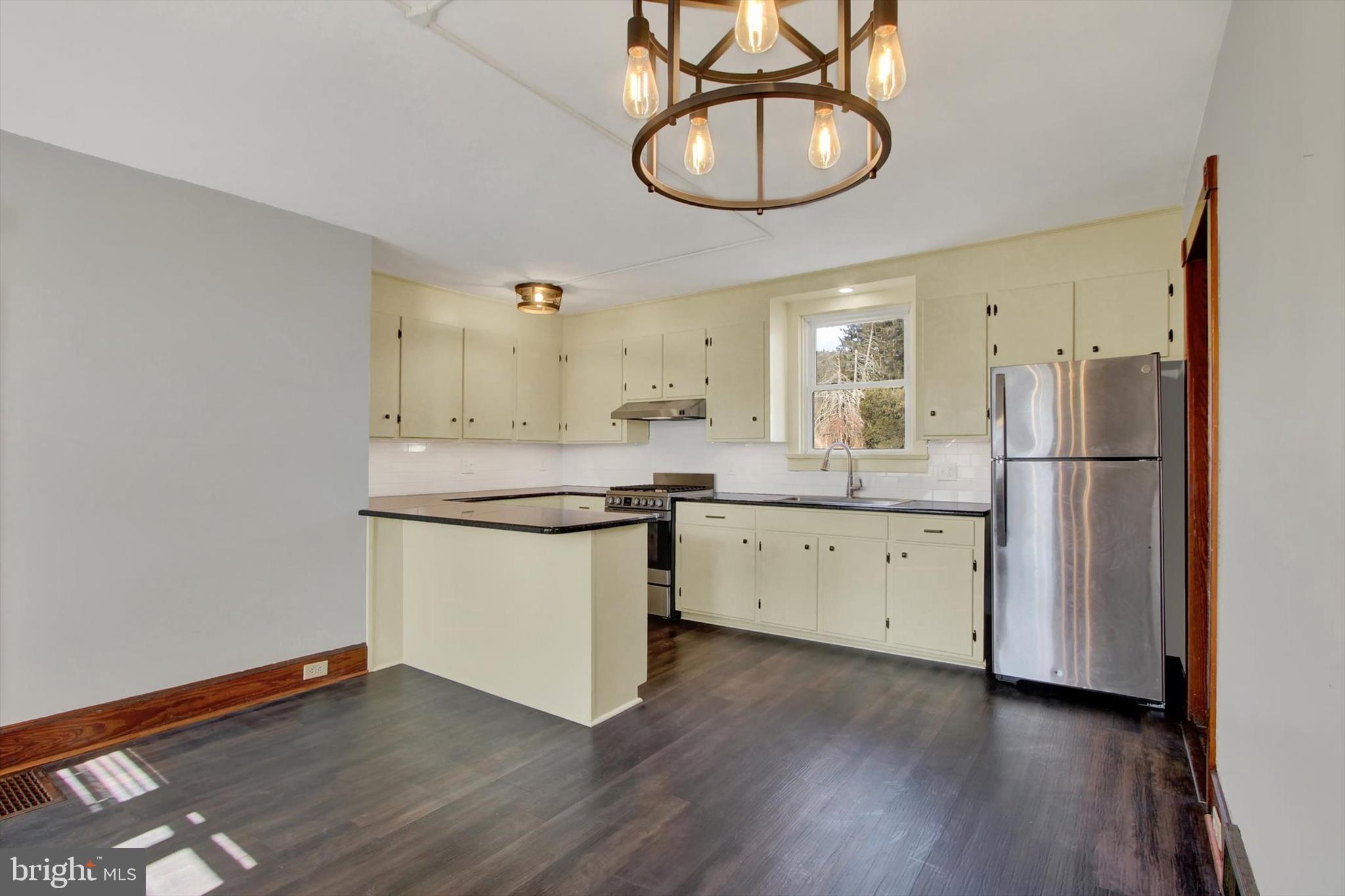 367 High Street Orrtanna, PA 17353 - Photo 15 of 26 a kitchen with stainless steel appliances granite countertop a refrigerator a sink dishwasher a stove and white countertops with wooden floor