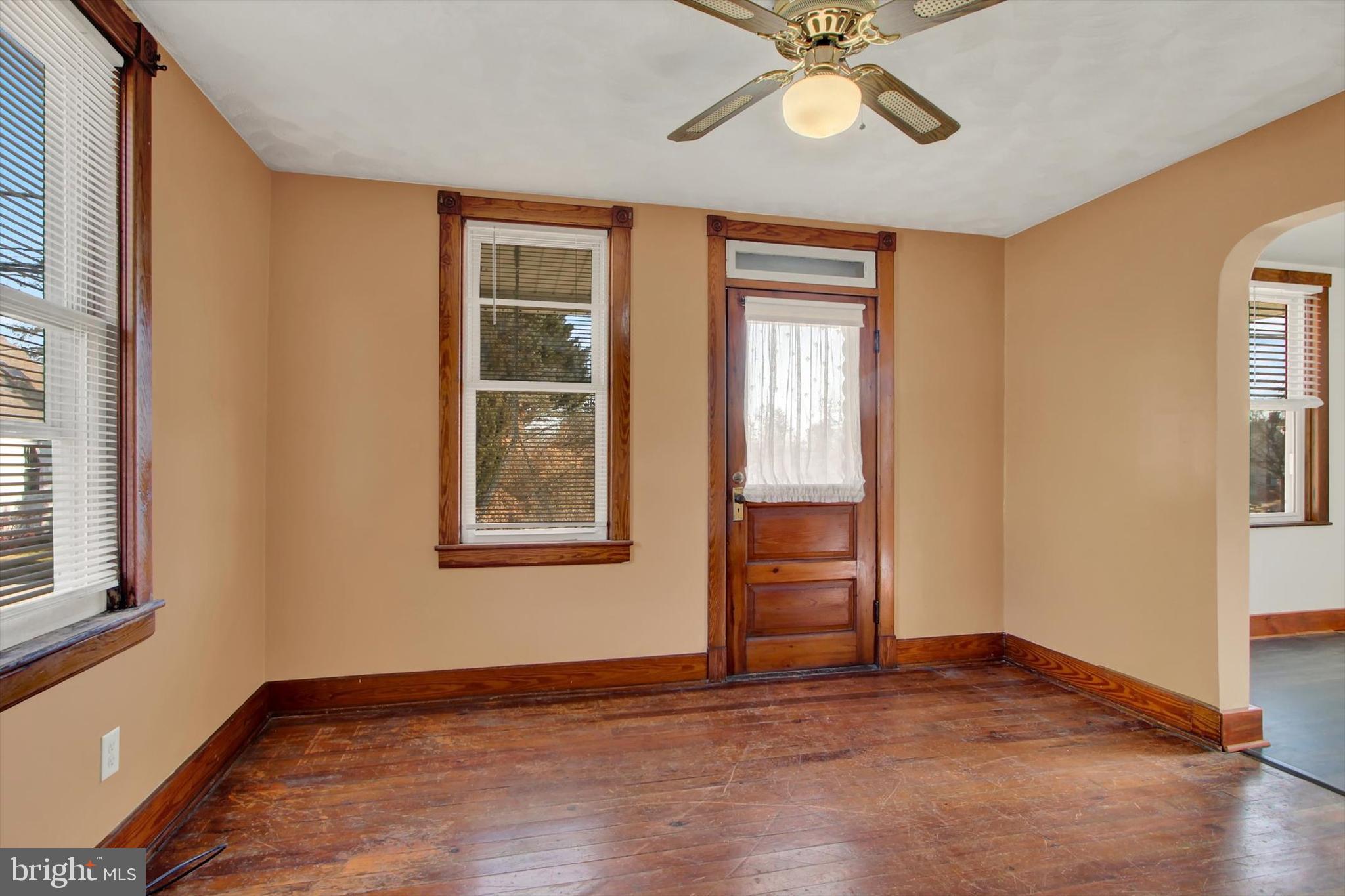 367 High Street Orrtanna, PA 17353 - Photo 6 of 26 an empty room with wooden floor chandelier fan and windows