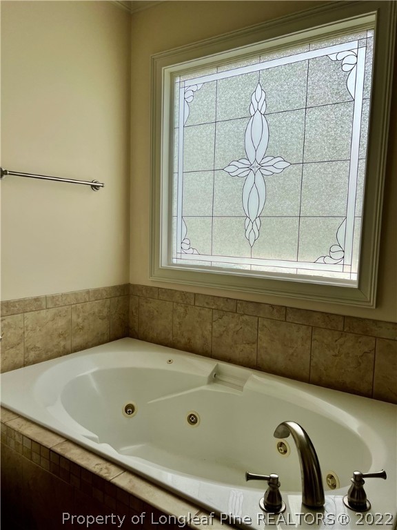 2633 Plum Ridge Road Fayetteville, NC 28306 - Photo 29 of 50 a bathroom with a tub and a window