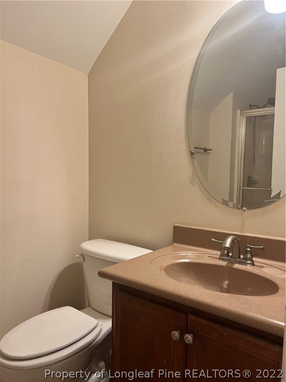 2633 Plum Ridge Road Fayetteville, NC 28306 - Photo 32 of 50 a bathroom with a sink a toilet and mirror