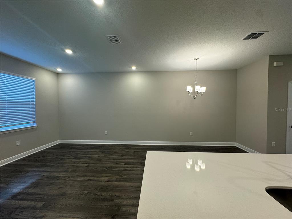 16333 Hamlin Hills Road Winter Garden, FL 34787 - Photo 11 of 35 an empty room with wooden floor