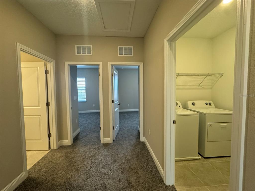 16333 Hamlin Hills Road Winter Garden, FL 34787 - Photo 17 of 35 a view of a hallway with a wooden door