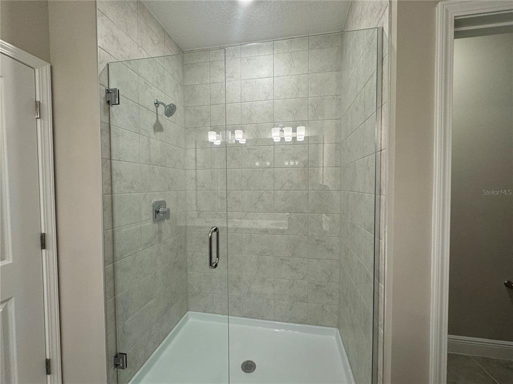16333 Hamlin Hills Road Winter Garden, FL 34787 - Photo 30 of 35 a bathroom with a shower and toilet
