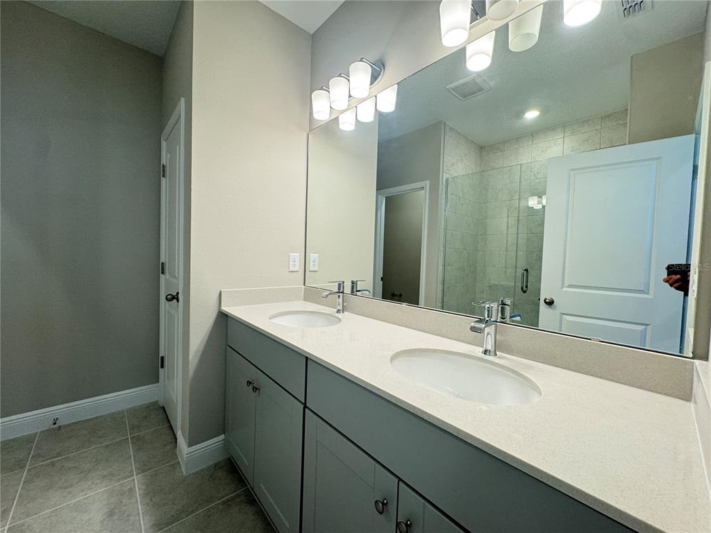 16333 Hamlin Hills Road Winter Garden, FL 34787 - Photo 33 of 35 a bathroom with a sink double vanity and a mirror
