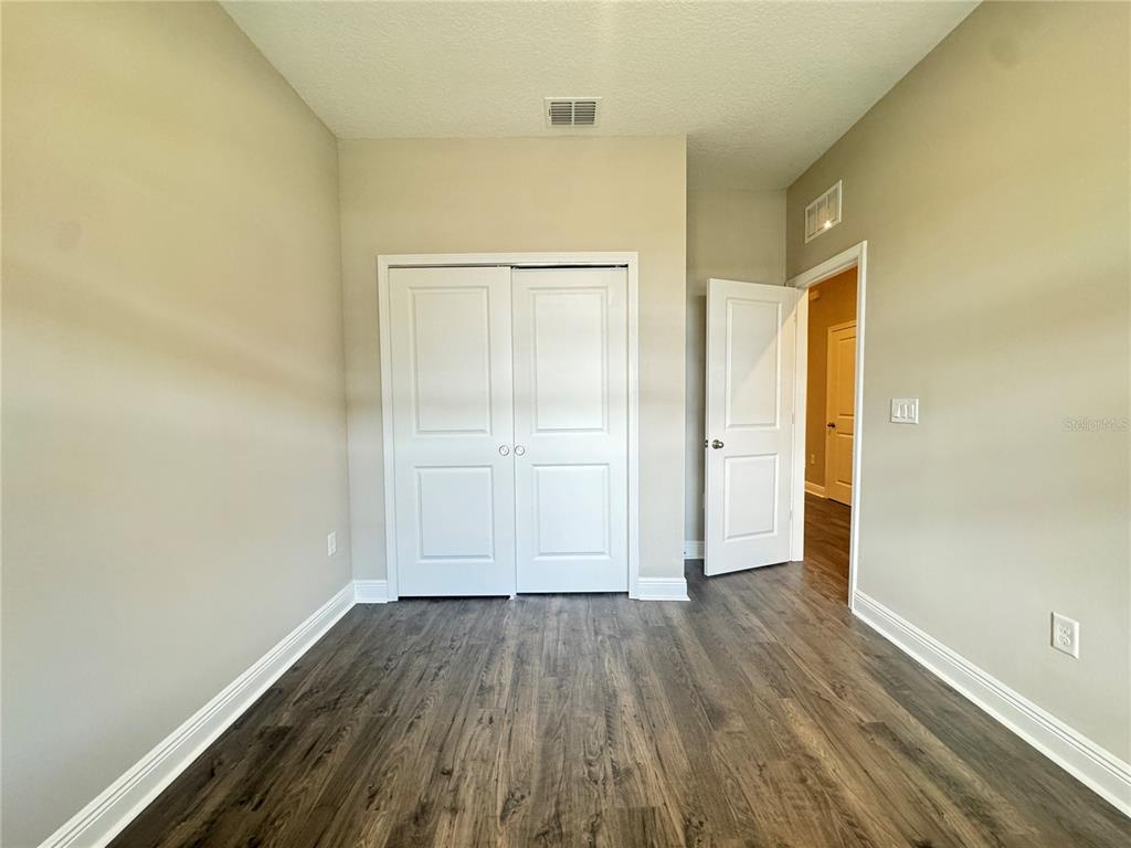 16333 Hamlin Hills Road Winter Garden, FL 34787 - Photo 5 of 35 an empty room with wooden floor