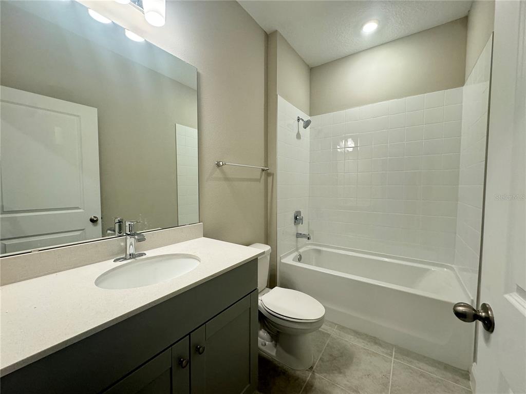 16333 Hamlin Hills Road Winter Garden, FL 34787 - Photo 6 of 35 a bathroom with a sink a toilet and shower