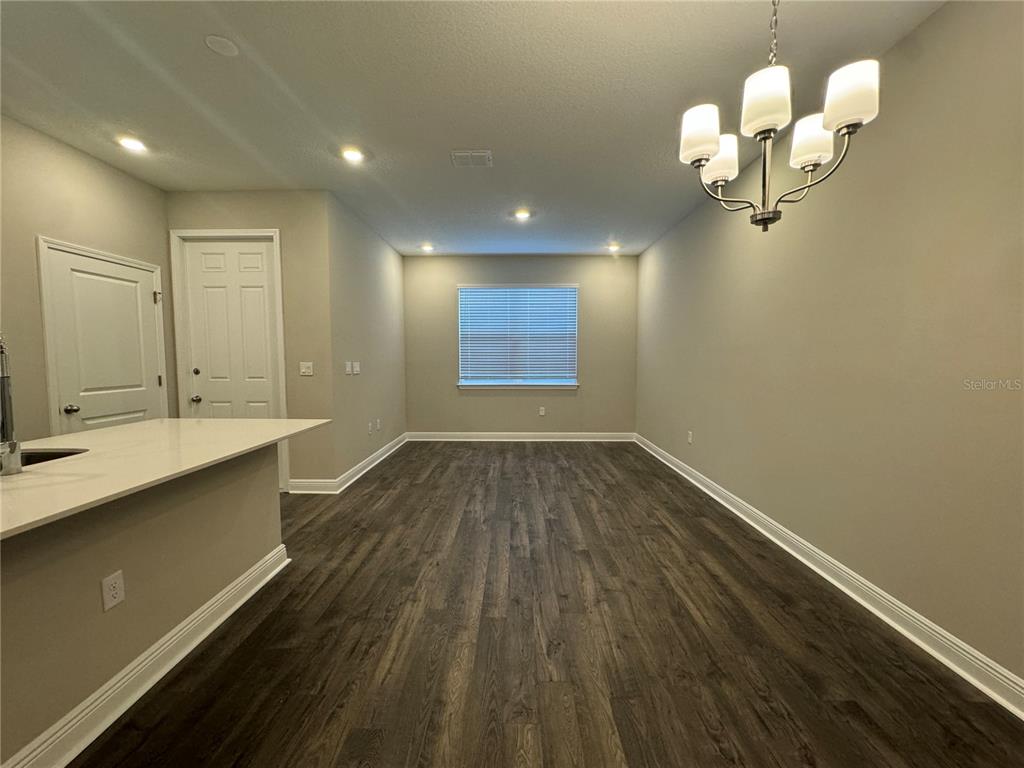 16333 Hamlin Hills Road Winter Garden, FL 34787 - Photo 10 of 35 a view of a room with wooden floor and staircase