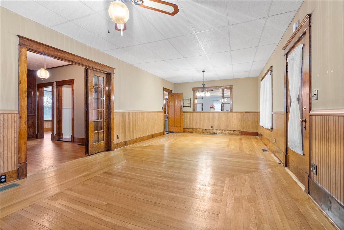 112 East Jefferson Street Dana, IL 61321 - Photo 14 of 40 a view of an empty room with a window and wooden floor