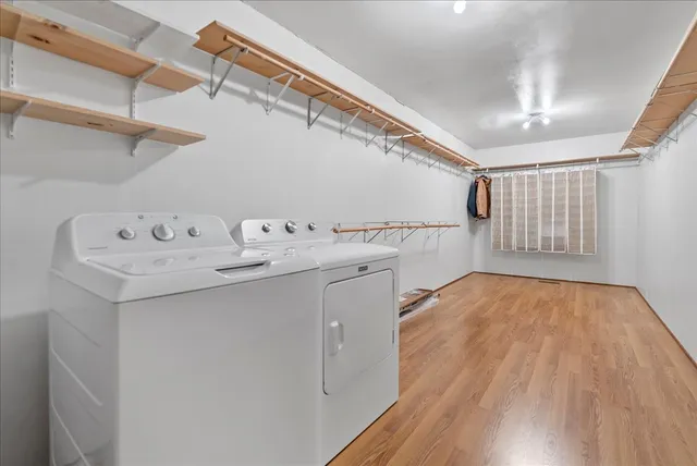 a utility room with cabinets washer and dryer