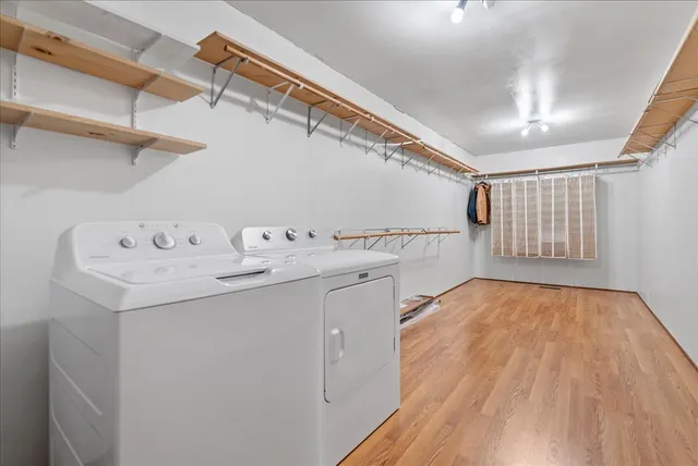 a utility room with cabinets washer and dryer