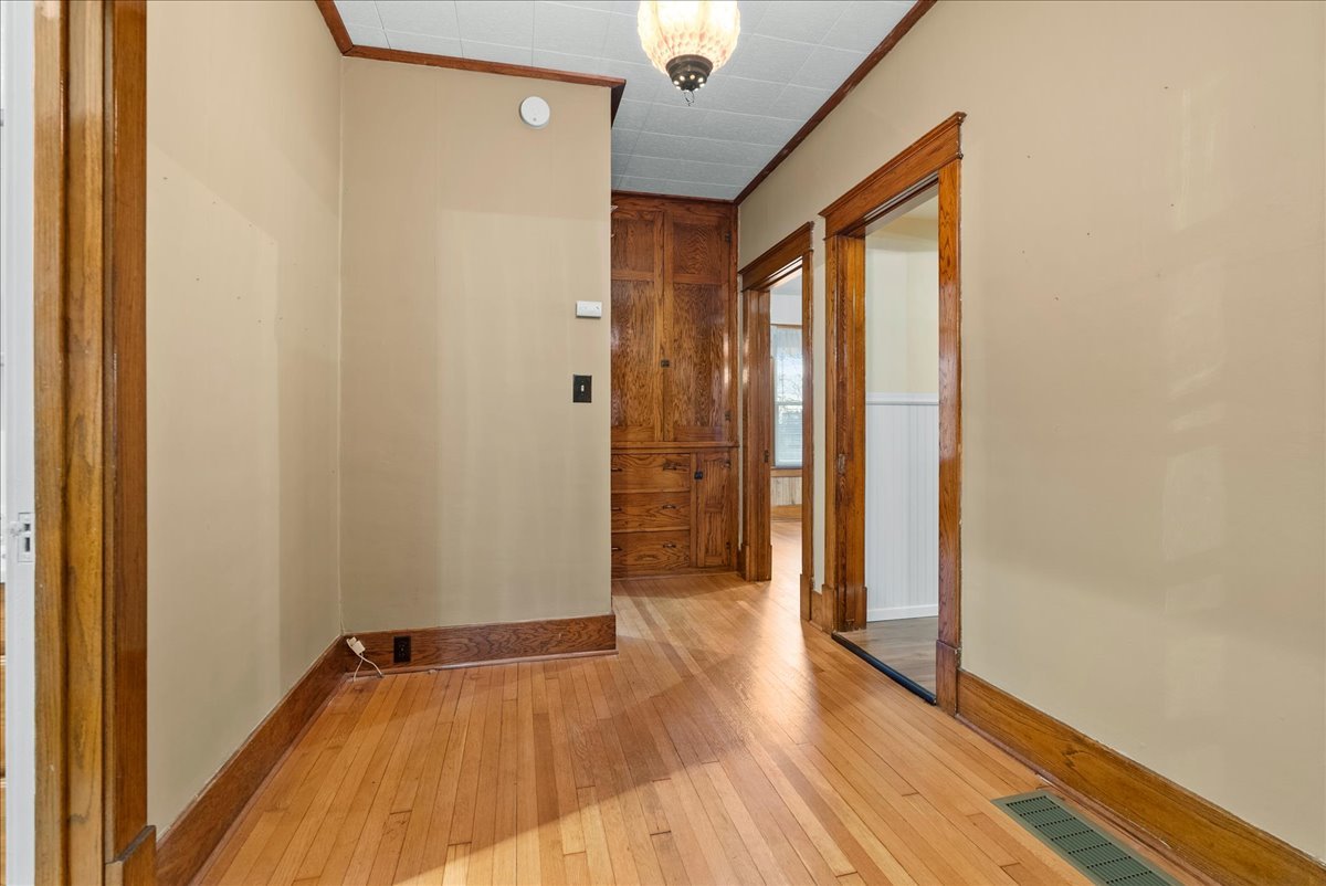 112 East Jefferson Street Dana, IL 61321 - Photo 21 of 40 a view of a hallway with wooden floor and a bathroom