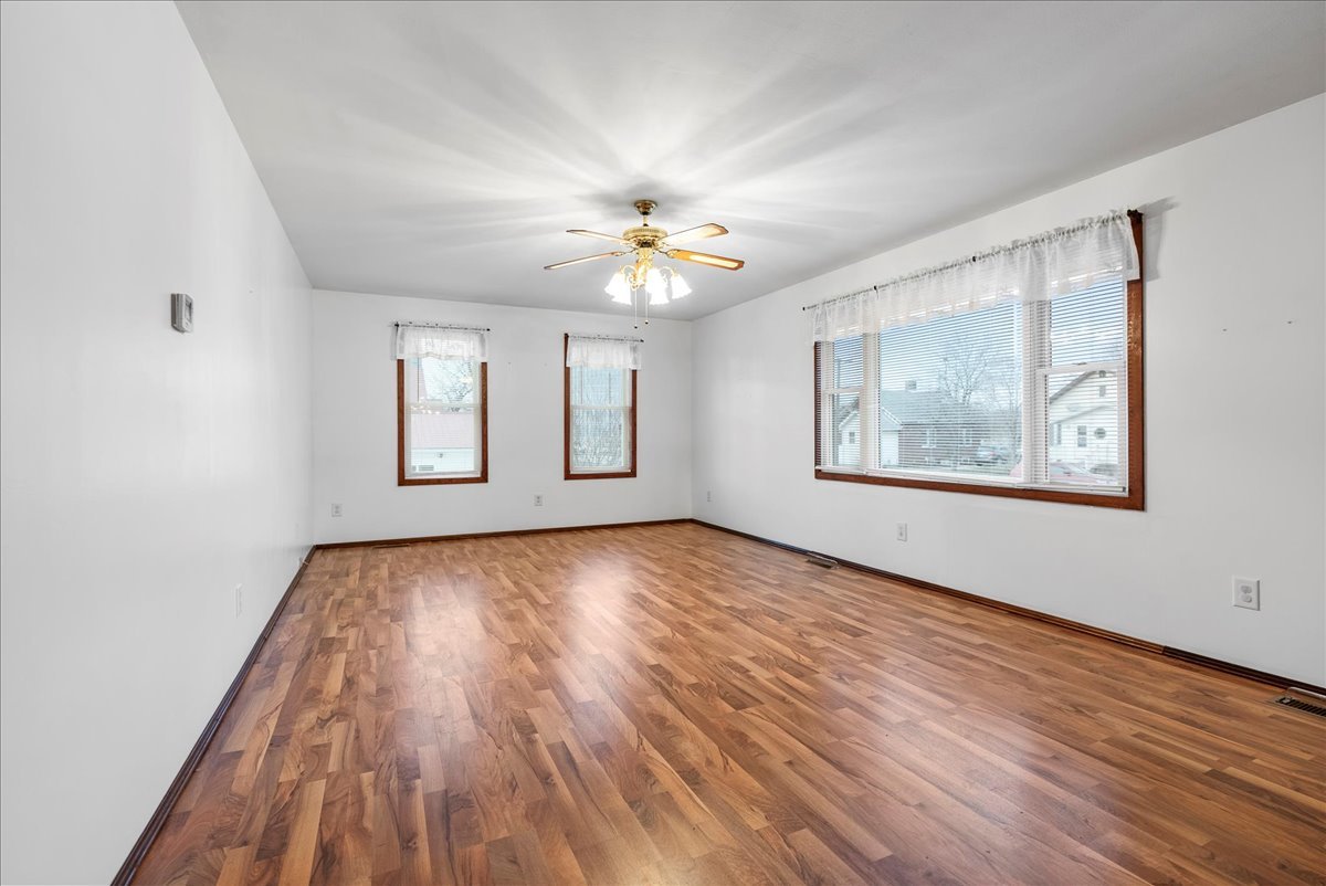112 East Jefferson Street Dana, IL 61321 - Photo 23 of 40 a view of an empty room with a window and wooden floor