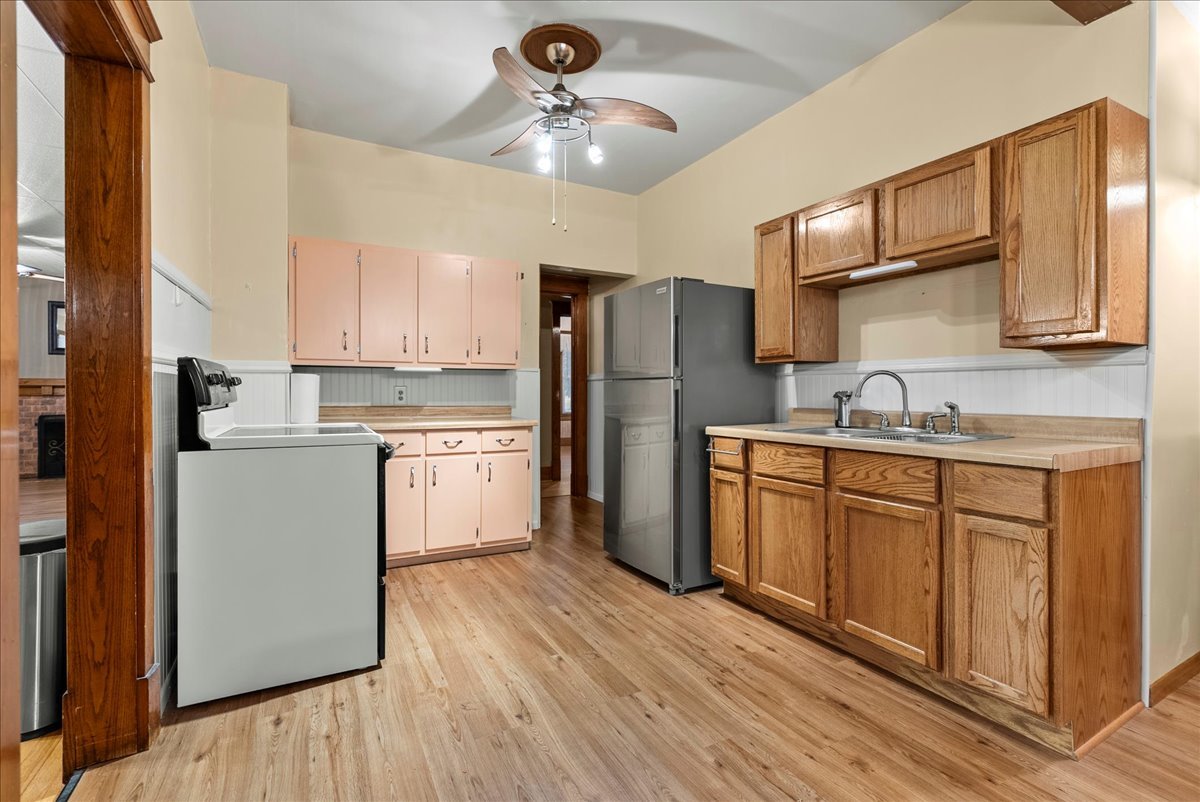 112 East Jefferson Street Dana, IL 61321 - Photo 25 of 40 a kitchen with a refrigerator cabinets stainless steel appliances and a center island