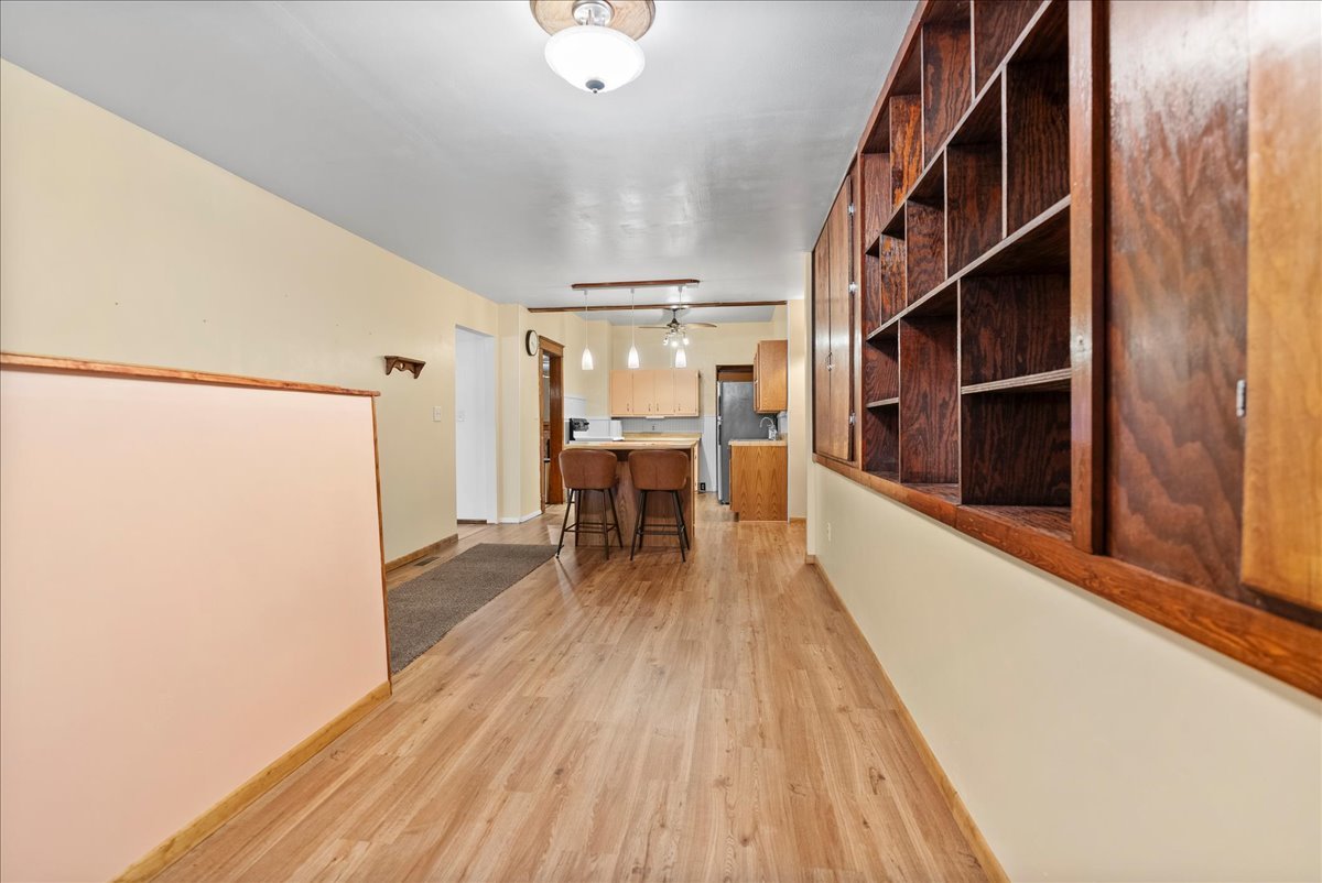 112 East Jefferson Street Dana, IL 61321 - Photo 26 of 40 a hallway with wooden floor stairs and furniture