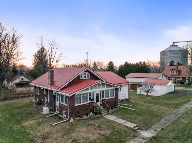 a aerial view of a house with a yard and sitting area