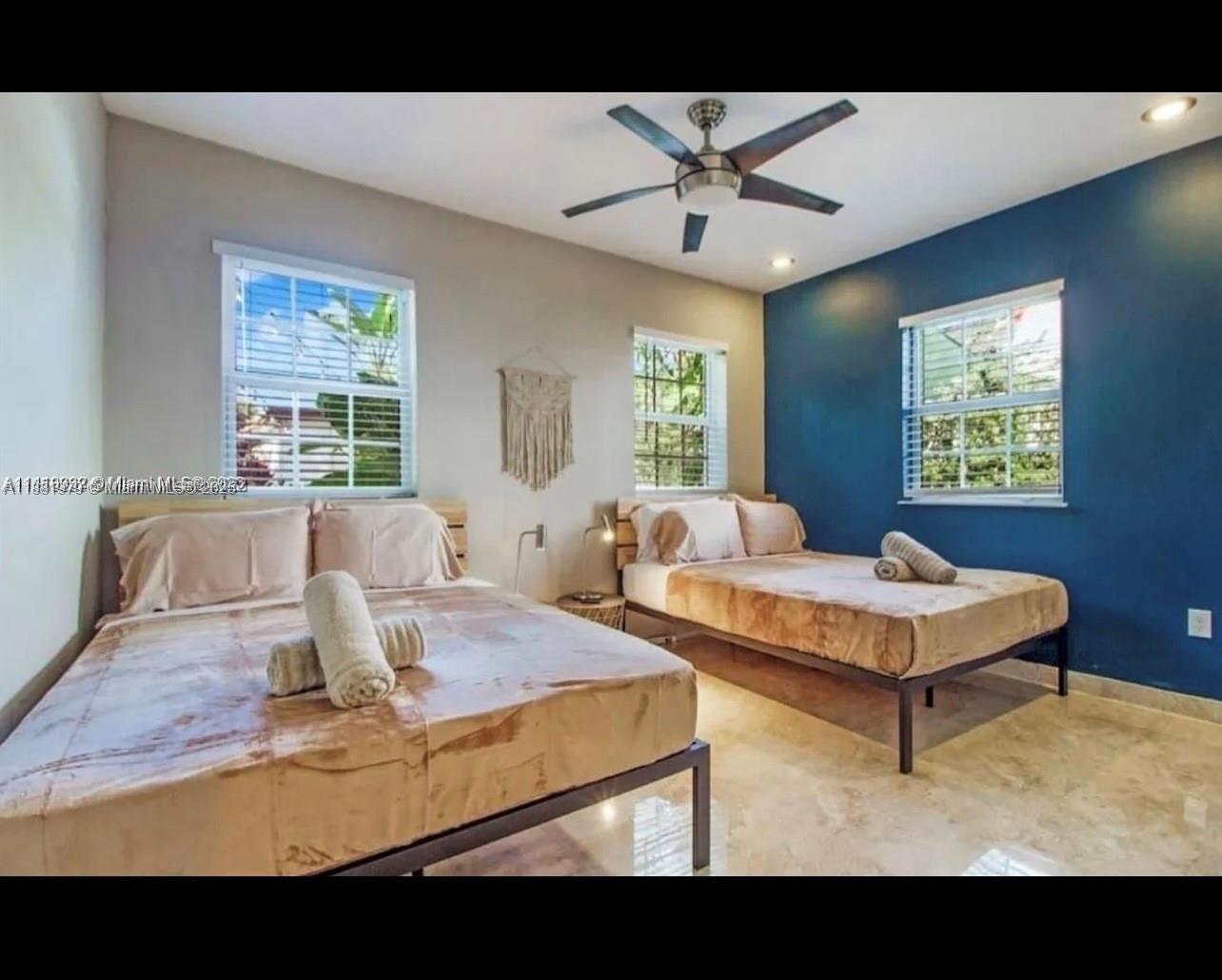 149 Northwest 48th Street Miami, FL 33127 - Photo 16 of 24 a living room with furniture and a large window