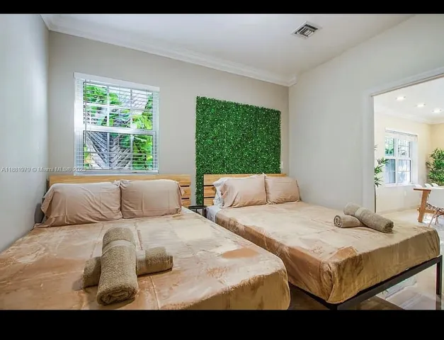 a bedroom with a bed and a large window