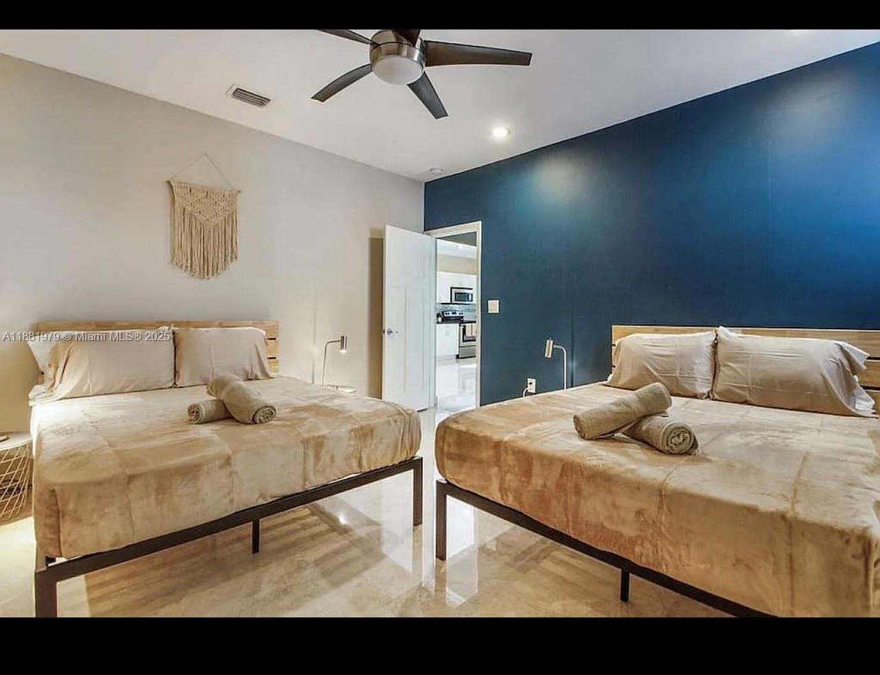 149 Northwest 48th Street Miami, FL 33127 - Photo 3 of 24 a bedroom with a bed and a dresser