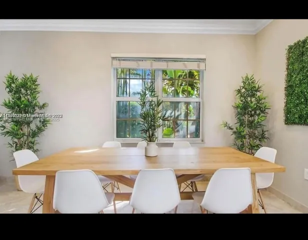 a view of table and chair with potted plant
