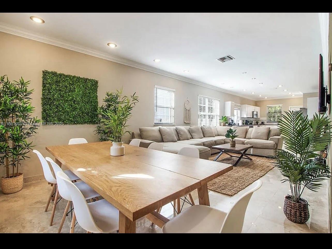 149 Northwest 48th Street Miami, FL 33127 - Photo 7 of 24 a living room with furniture potted plant and a window