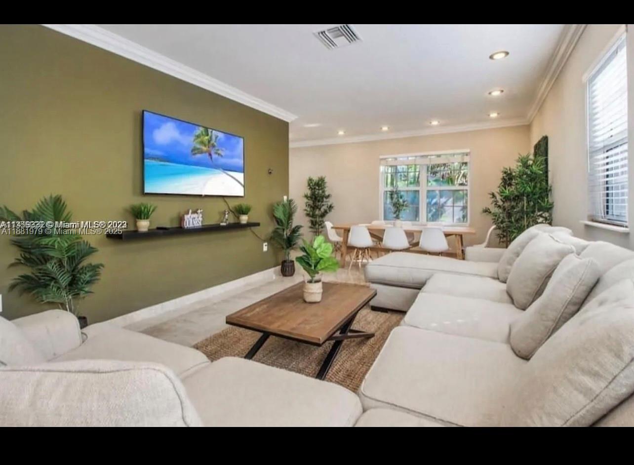 149 Northwest 48th Street Miami, FL 33127 - Photo 10 of 24 a living room with furniture and a flat screen tv