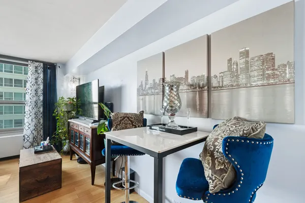 a dining room with furniture and a floor to ceiling window
