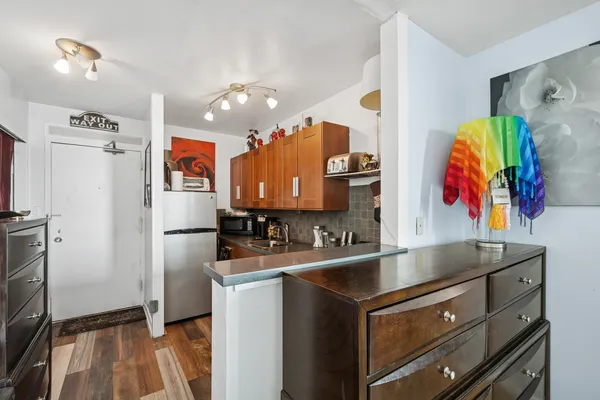 a kitchen with stainless steel appliances granite countertop a refrigerator and a sink