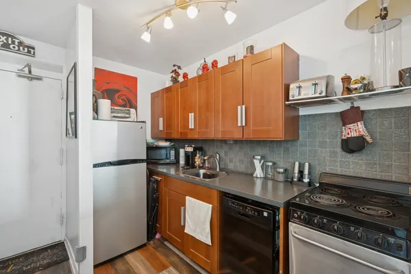 a kitchen with stainless steel appliances granite countertop a refrigerator a sink and dishwasher