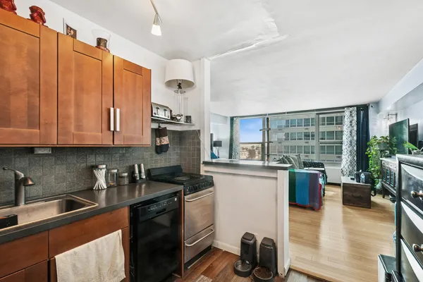 a kitchen with a sink stove and cabinets