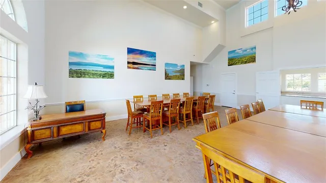 a view of a dining room with furniture and a chandelier
