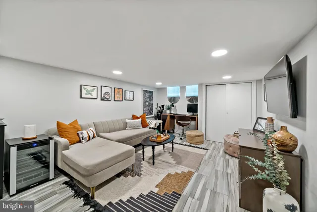 a living room with furniture a wooden floor and a sink