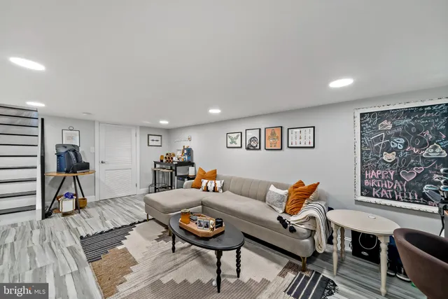 a living room with furniture a rug and a table