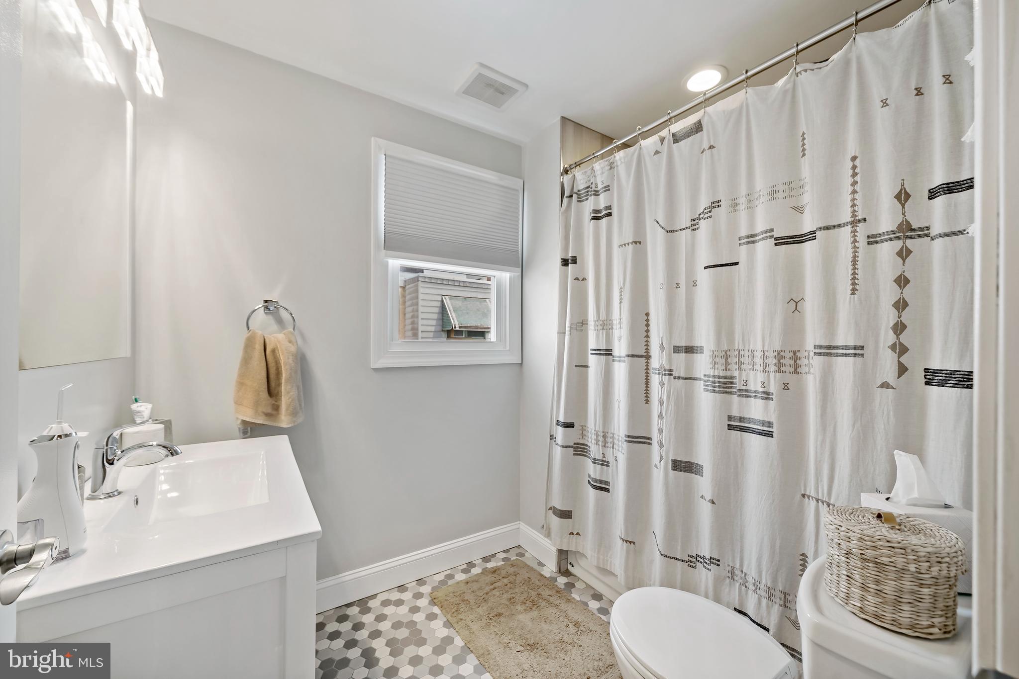 1225 Tree Street Philadelphia, PA 19148 - Photo 15 of 18 a bathroom with a sink toilet a shower and a mirror