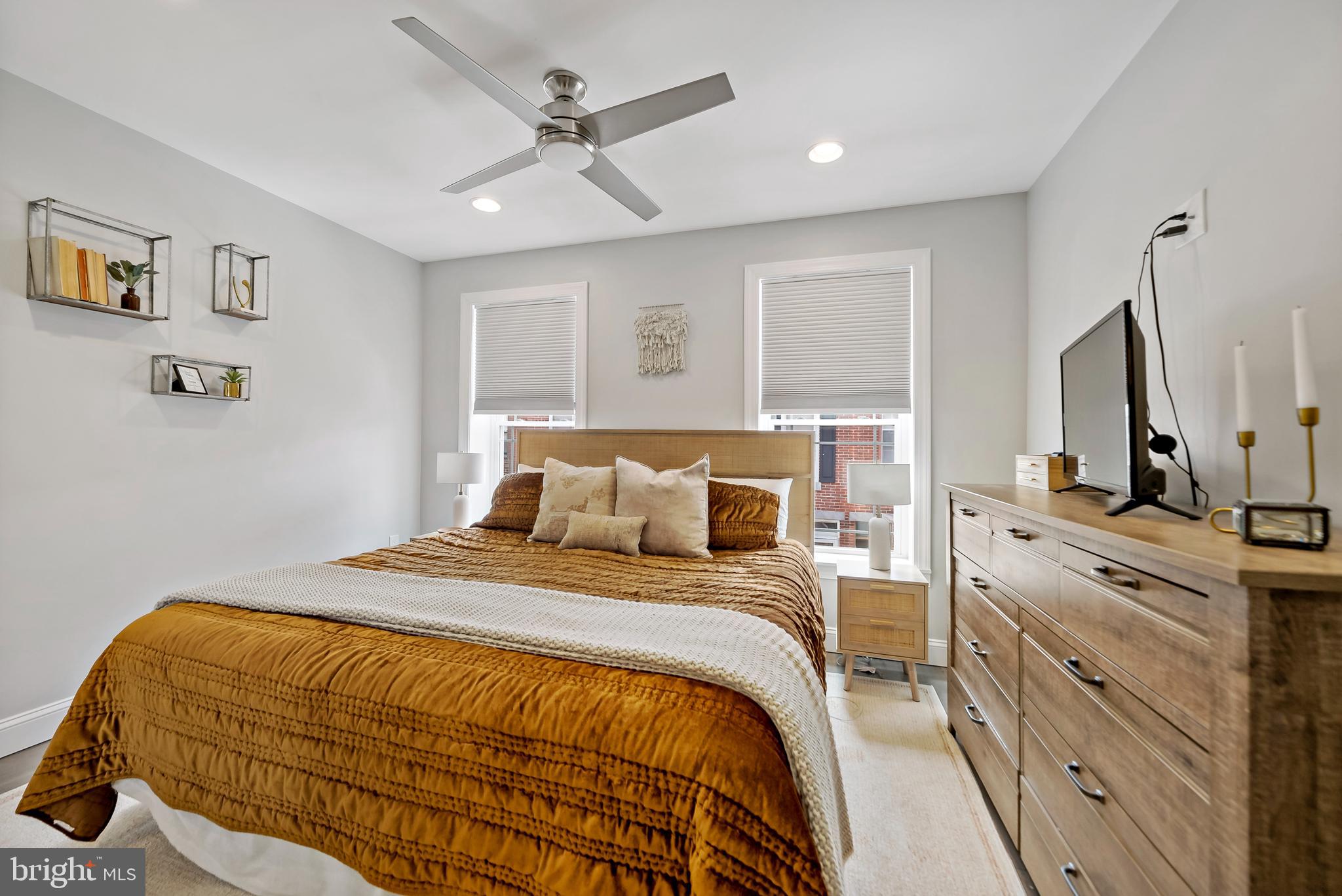 1225 Tree Street Philadelphia, PA 19148 - Photo 17 of 18 a bedroom with a bed a window and dresser