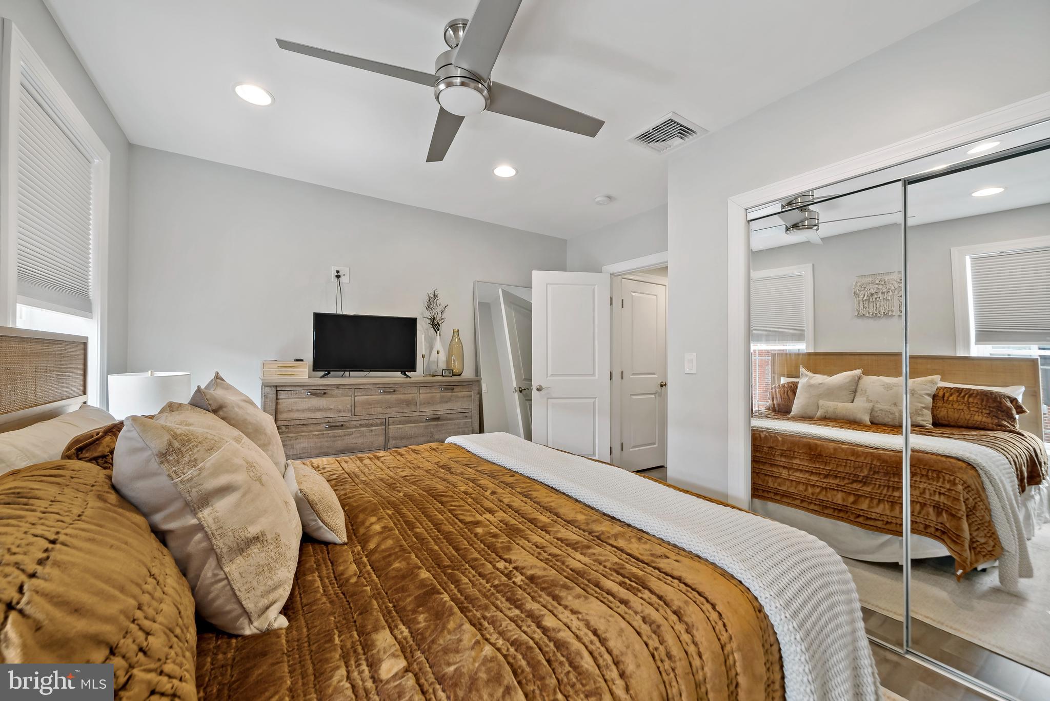 1225 Tree Street Philadelphia, PA 19148 - Photo 18 of 18 a bedroom with a bed window and a flat screen tv