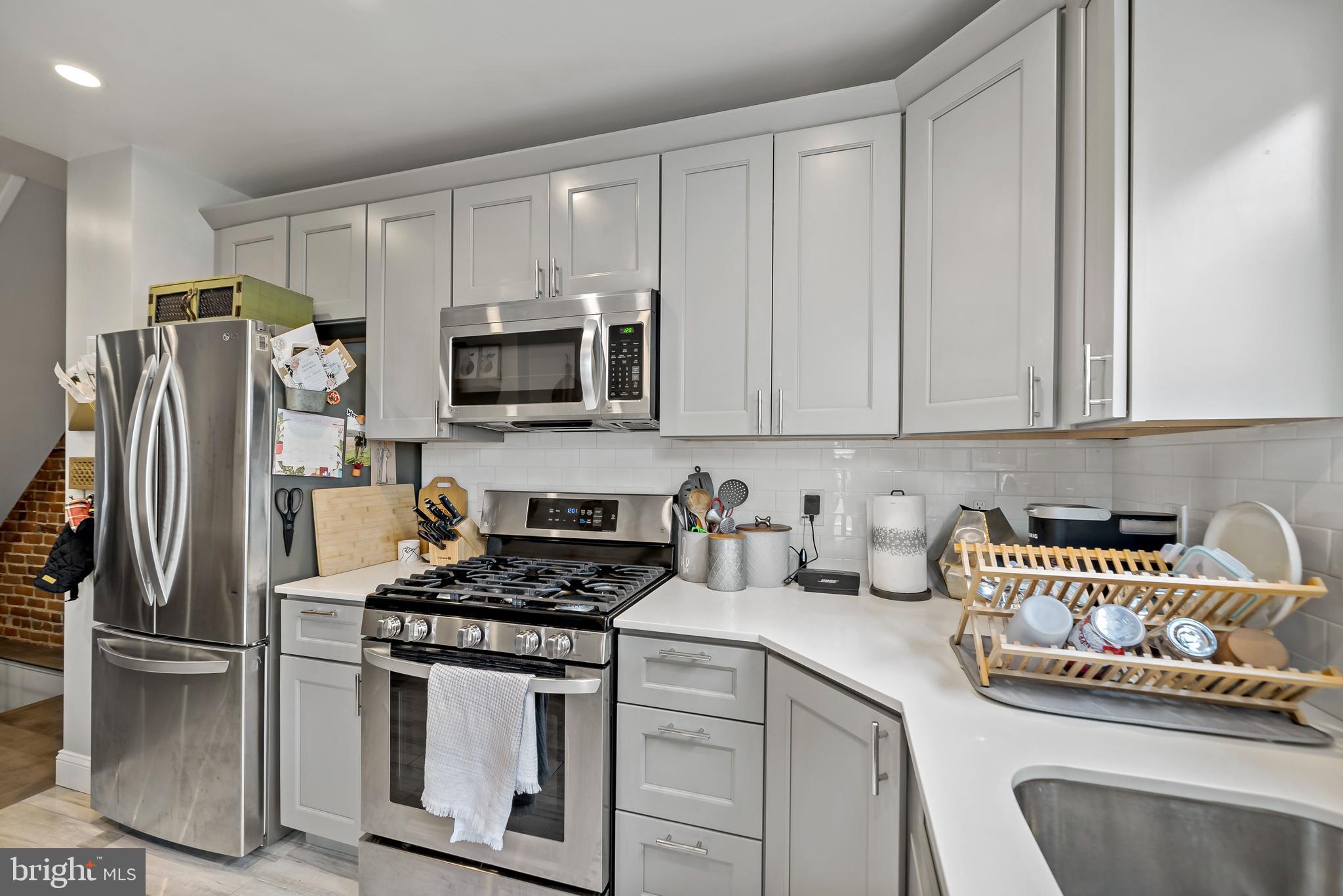 1225 Tree Street Philadelphia, PA 19148 - Photo 10 of 18 a kitchen with stainless steel appliances a refrigerator a stove top oven a sink and cabinets