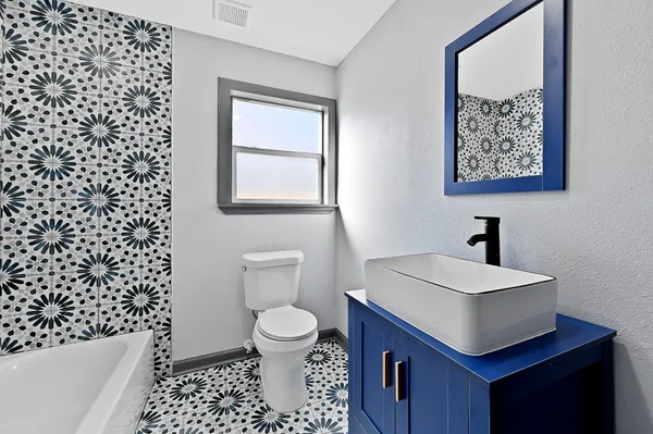 a bathroom with a sink a toilet and a shower