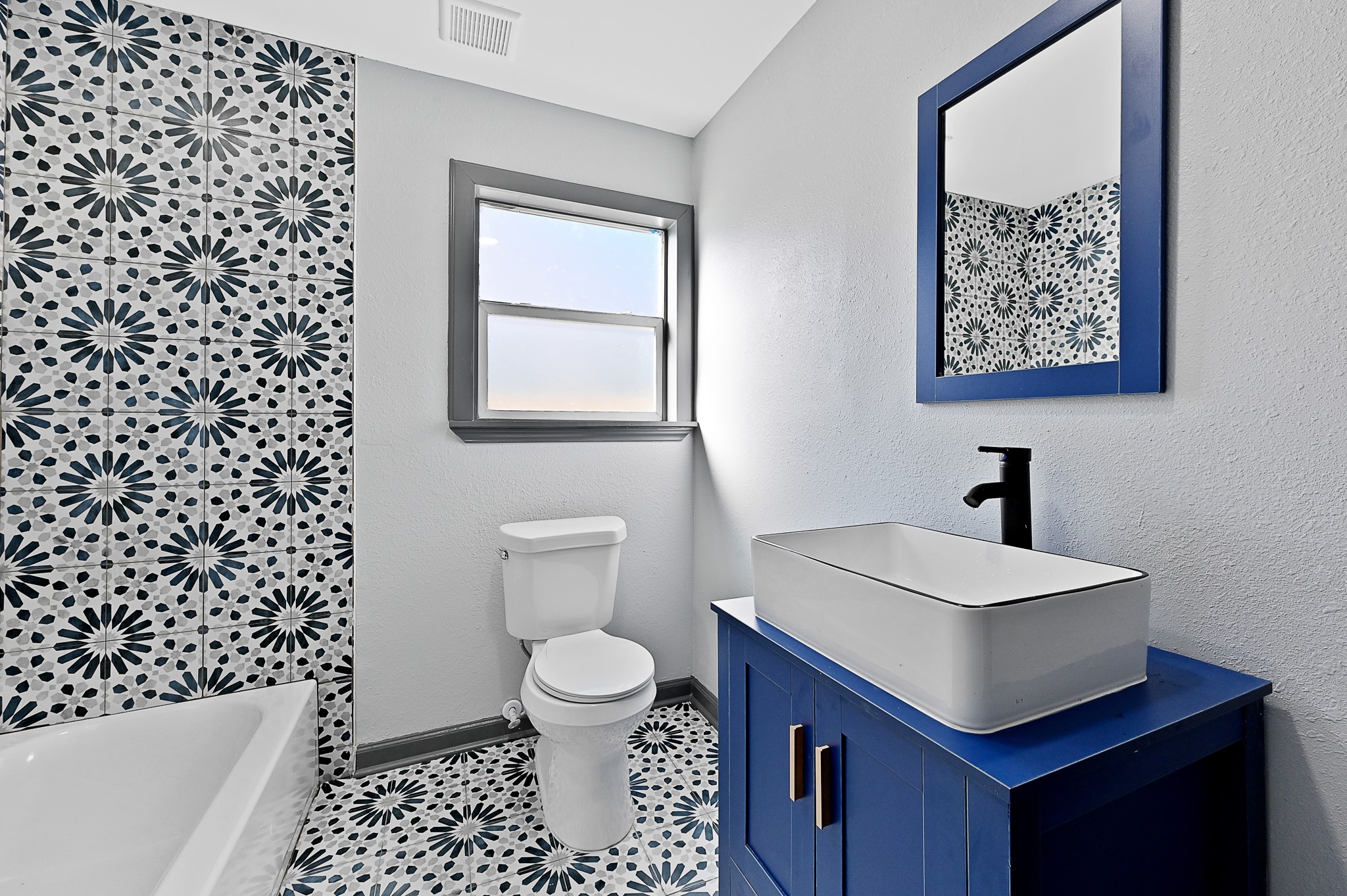 4406 Edison Street Houston, TX 77009 - Photo 11 of 42 a bathroom with a sink a toilet and a shower