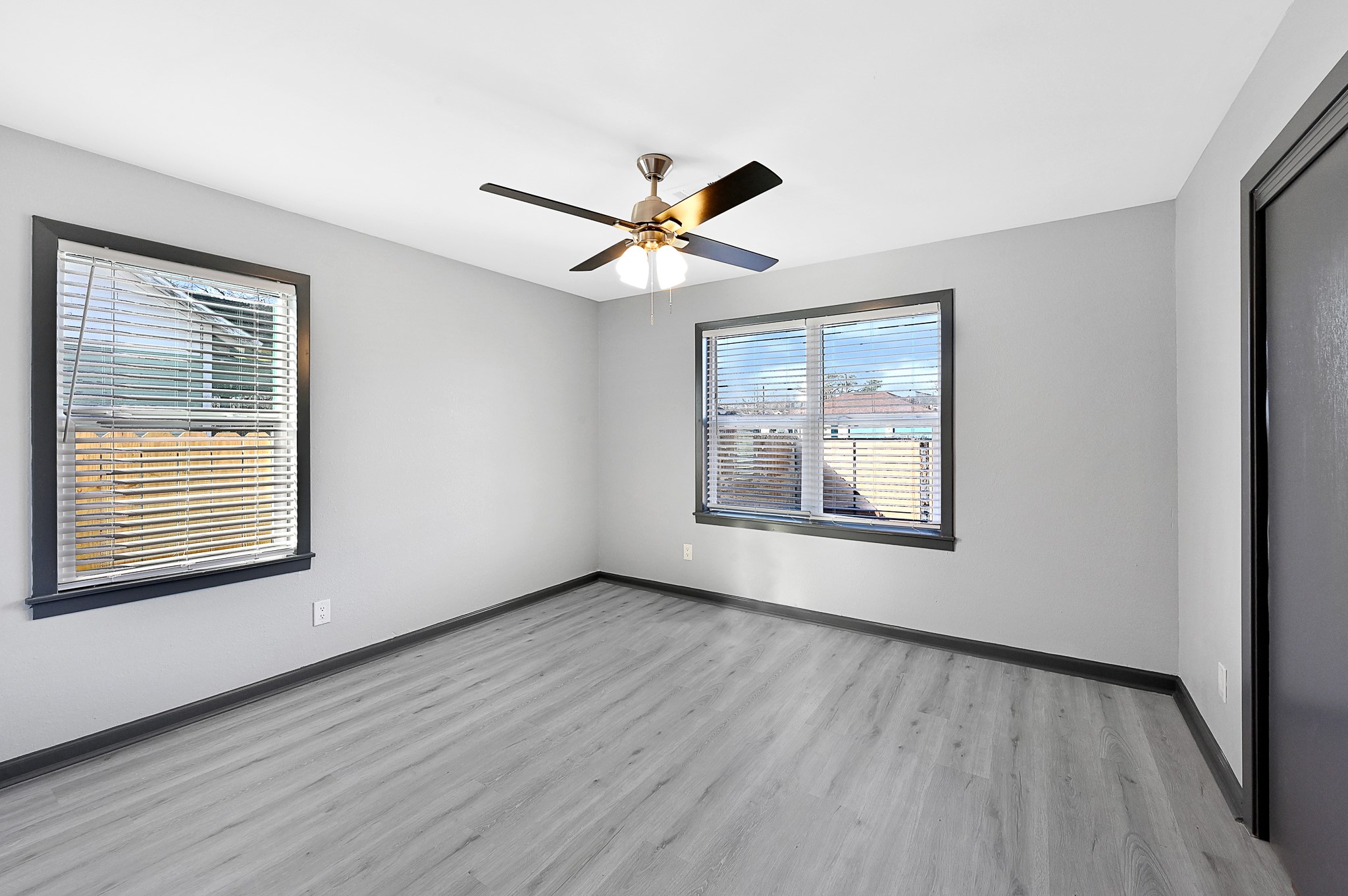 4406 Edison Street Houston, TX 77009 - Photo 13 of 42 a view of an empty room with window and wooden floor