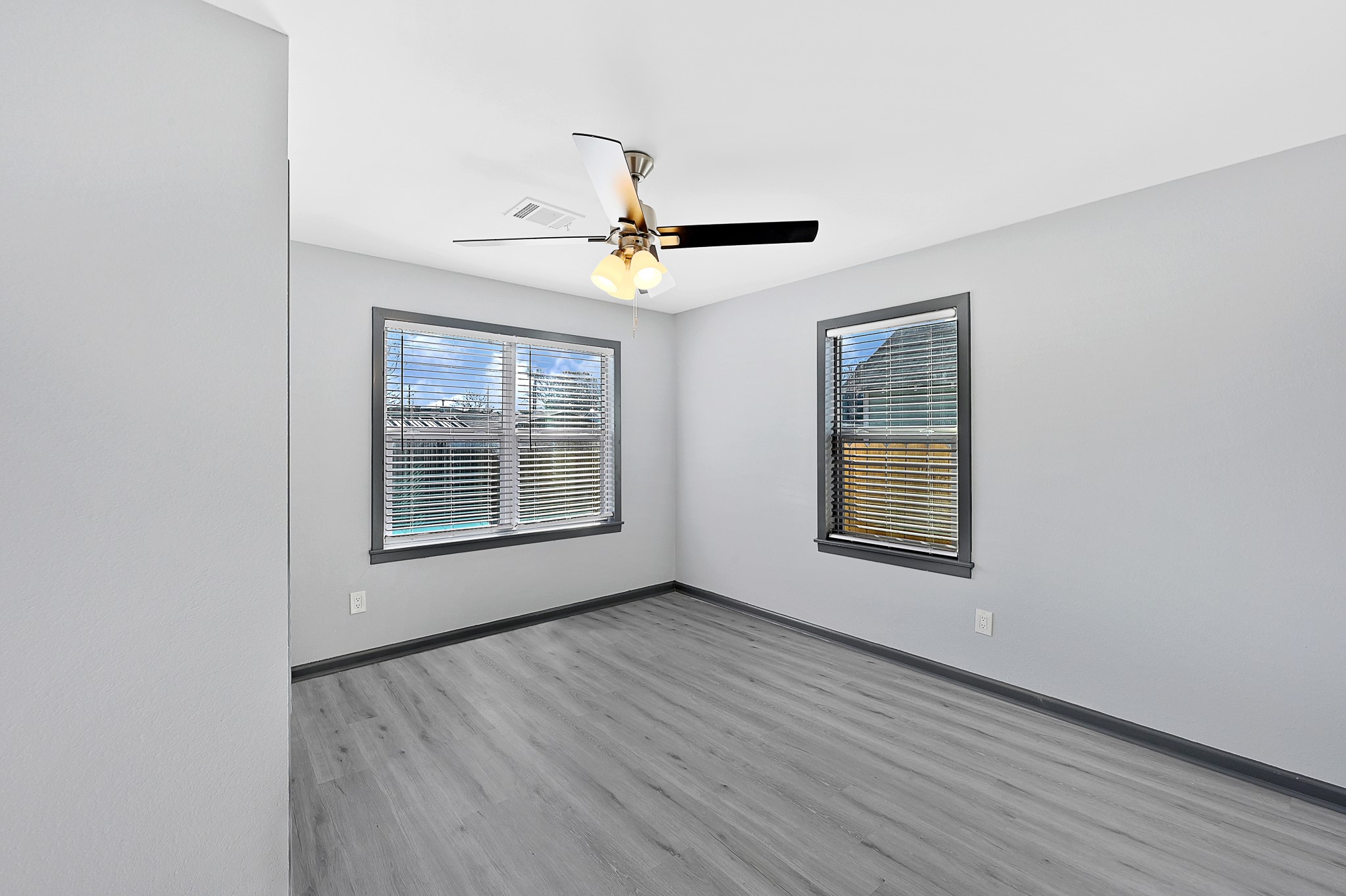 4406 Edison Street Houston, TX 77009 - Photo 14 of 42 a view of an empty room with a window and a chandelier fan