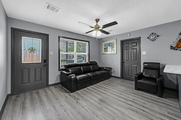 a living room with furniture and a wooden floor